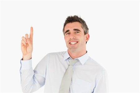 simsearch:400-05895521,k - Smiling businessman pointing at copy space against a white background Stock Photo - Budget Royalty-Free & Subscription, Code: 400-04918107