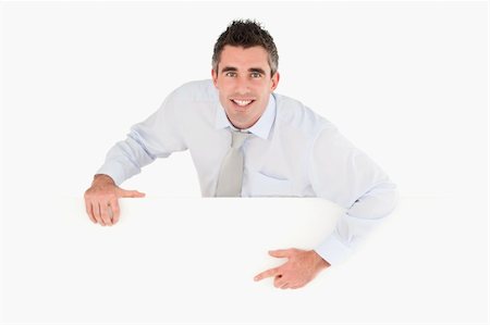Businessman pointing at blank panel against a white background Stock Photo - Budget Royalty-Free & Subscription, Code: 400-04918115