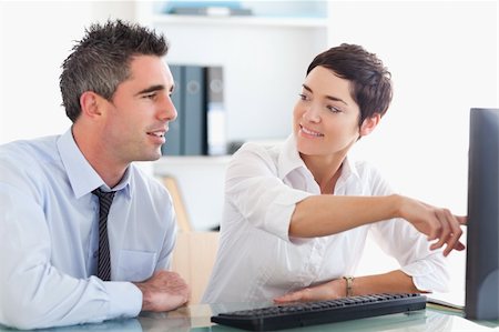 simsearch:400-04918393,k - Office worker pointing a something on a screen to her colleague in her office Stock Photo - Budget Royalty-Free & Subscription, Code: 400-04918145