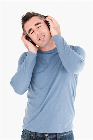 simsearch:400-05717354,k - Portrait of a man enjoying some music against a white background Stock Photo - Budget Royalty-Free & Subscription, Code: 400-04918289