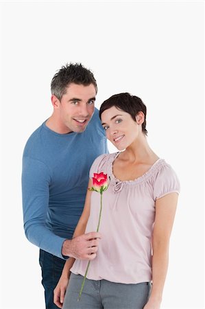 simsearch:400-05294518,k - Man offering a rose to his wife against a white background Fotografie stock - Microstock e Abbonamento, Codice: 400-04918367