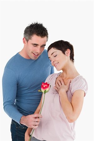 simsearch:400-05294518,k - Husband offering a rose to his happy wife against a white background Fotografie stock - Microstock e Abbonamento, Codice: 400-04918368