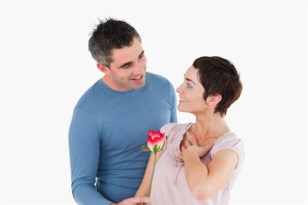 simsearch:400-05294518,k - Husband offering a rose to his delighted wife against a white background Fotografie stock - Microstock e Abbonamento, Codice: 400-04918369