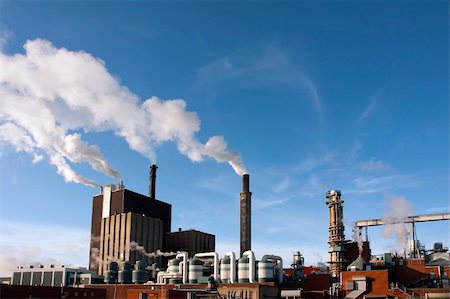 environmental issues petrochemicals - Factory with chimneys emmiting smoke on blue sky Stock Photo - Budget Royalty-Free & Subscription, Code: 400-04918700