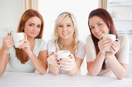 Cute Women sitting at a table with cups in a kitchen Stock Photo - Budget Royalty-Free & Subscription, Code: 400-04919145