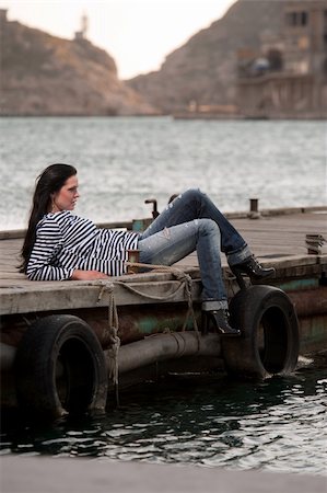 elegant dock - woman lying on a pier in the background of the sea. Crimea, Ukraine Stock Photo - Budget Royalty-Free & Subscription, Code: 400-04910107