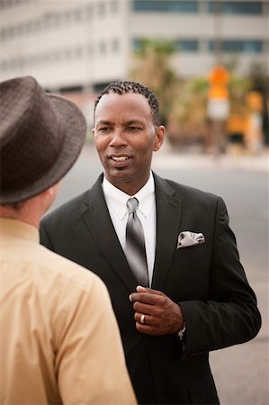 Handsome African-American businessman chats with his friend Stock Photo - Budget Royalty-Free & Subscription, Code: 400-04910546