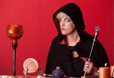 simsearch:400-05347613,k - Caucasian witch holds sceptre over red background Stock Photo - Budget Royalty-Free & Subscription, Code: 400-04910578