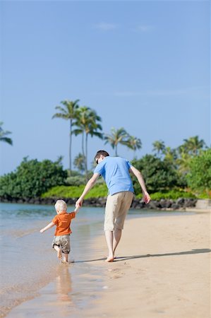 father and son having fun on a tropical beach Stock Photo - Budget Royalty-Free & Subscription, Code: 400-04910628