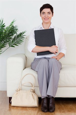 Portrait of a Brunette short-haired woman sitting on a sofa in a waiting room Stock Photo - Budget Royalty-Free & Subscription, Code: 400-04910839