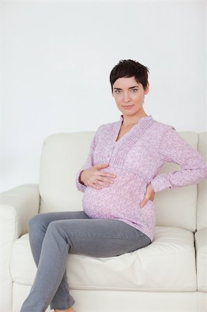 Pregnant woman sitting on a sofa in a waiting room Stock Photo - Budget Royalty-Free & Subscription, Code: 400-04910868