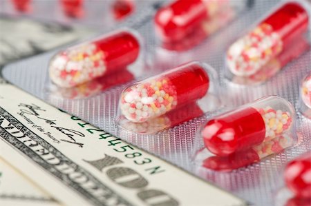 dollar sign of pills - red tablets on a money closeup Stock Photo - Budget Royalty-Free & Subscription, Code: 400-04911607