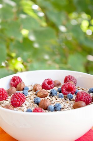 Oat nuts with fresh blueberries and raspberries and hazelnuts Stock Photo - Budget Royalty-Free & Subscription, Code: 400-04911977