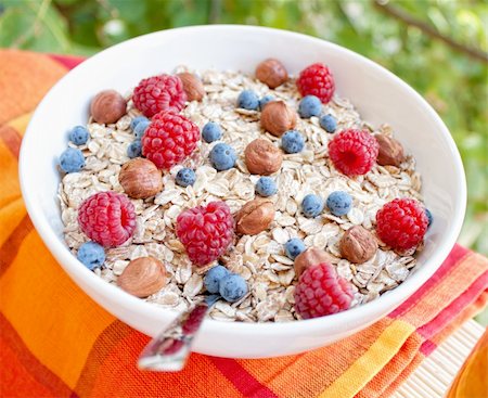 Oat nuts with fresh blueberries and raspberries and hazelnuts Stock Photo - Budget Royalty-Free & Subscription, Code: 400-04911972