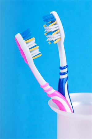 A couple of toothbrushes over blue background Stock Photo - Budget Royalty-Free & Subscription, Code: 400-04912074