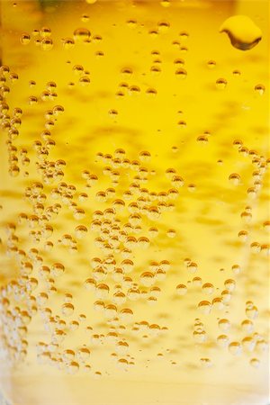 Orange beer with bubbles background. Closeup view. Photographie de stock - Aubaine LD & Abonnement, Code: 400-04912079