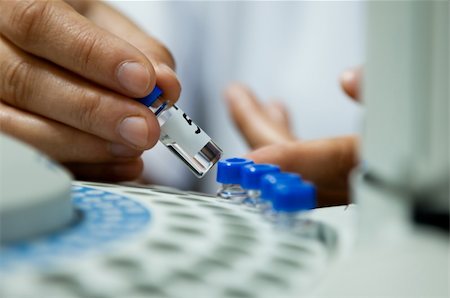 laborant inserting laboratory glass bottle in  a chromatograph vial Stock Photo - Budget Royalty-Free & Subscription, Code: 400-04912391