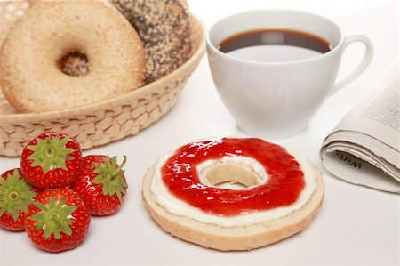 Breakfast with fresh bagels served with cream cheese, strawberry marmalade, coffee and a newspaper Stock Photo - Budget Royalty-Free & Subscription, Code: 400-04912934