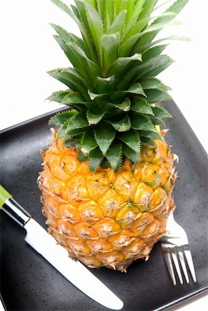 simsearch:400-04650758,k - ripe vivid pineapple on a black plate with knife and fork Stock Photo - Budget Royalty-Free & Subscription, Code: 400-04913344