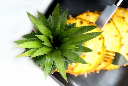 simsearch:400-04650758,k - ripe vibrant pineapple sliced on a black plate with knife and fork Stock Photo - Budget Royalty-Free & Subscription, Code: 400-04913342