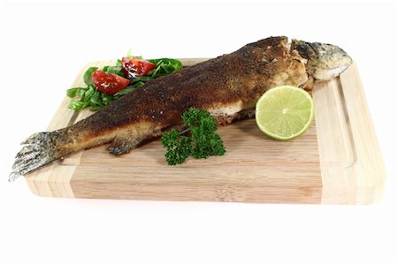 fresh trout Miller with lettuce, tomatoes and lime Stock Photo - Budget Royalty-Free & Subscription, Code: 400-04913494