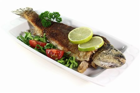 fresh trout Miller with lettuce, tomatoes and lime Stock Photo - Budget Royalty-Free & Subscription, Code: 400-04913495