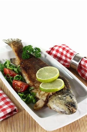 fresh trout Miller with lettuce, tomatoes and lime Stock Photo - Budget Royalty-Free & Subscription, Code: 400-04913493