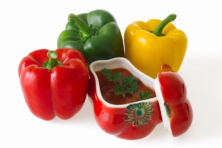 simsearch:400-06061963,k - Red, green and yellow bell pepper with a ceramic ornament in shape of red pepper field with paprika ragout isolated on white background Foto de stock - Royalty-Free Super Valor e Assinatura, Número: 400-04913668