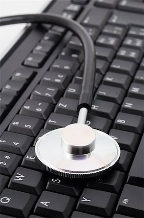 stethoscope on keyboard showing computer problem concept Stock Photo - Budget Royalty-Free & Subscription, Code: 400-04913680