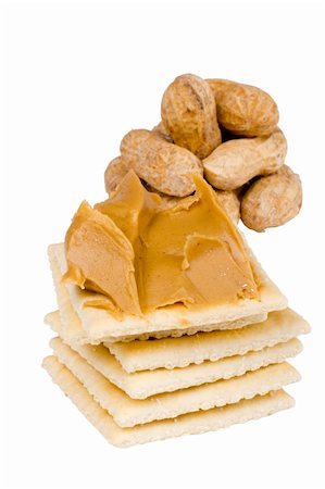 Cracker with peanut butter and peanuts in the background on white. Stock Photo - Budget Royalty-Free & Subscription, Code: 400-04925130