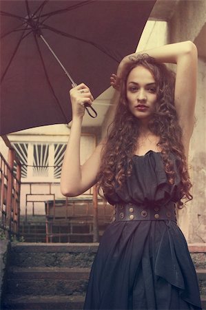 Beautiful fashion girl on the stairs with umbrella Stock Photo - Budget Royalty-Free & Subscription, Code: 400-04925309