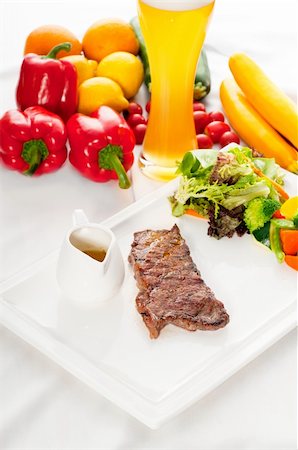 juicy BBQ grilled rib eye ,ribeye steak ,vegetables and lagher beer on background Stock Photo - Budget Royalty-Free & Subscription, Code: 400-04925336