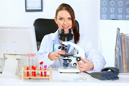 Smiling medical doctor woman using microscope in laboratory Stock Photo - Budget Royalty-Free & Subscription, Code: 400-04925807