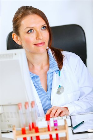 simsearch:400-04390415,k - Pretty medical doctor woman sitting at office table and dreaming Stock Photo - Budget Royalty-Free & Subscription, Code: 400-04925801