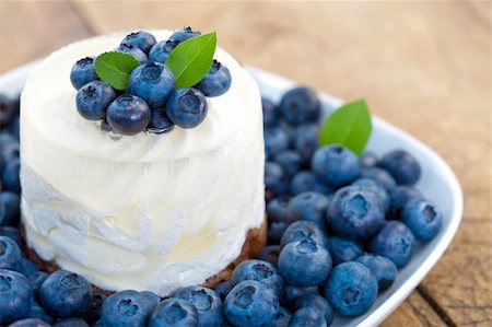 Blueberry cheesecake with fruits on a plate, rustic style Stock Photo - Budget Royalty-Free & Subscription, Code: 400-04920252