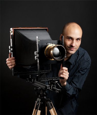 young man with retro camera in the dark Stock Photo - Budget Royalty-Free & Subscription, Code: 400-04920987