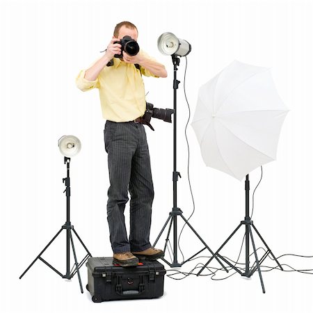 strebe - A professional photographer standing on a flight case to get a higher angle in a studio, surrounded by three strobes Stock Photo - Budget Royalty-Free & Subscription, Code: 400-04922092