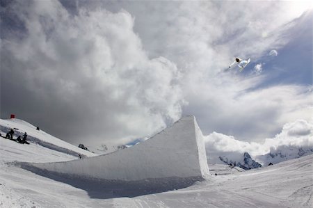 sky boarding - snowboarder taking big air jump with cloudy sky Stock Photo - Budget Royalty-Free & Subscription, Code: 400-04922899