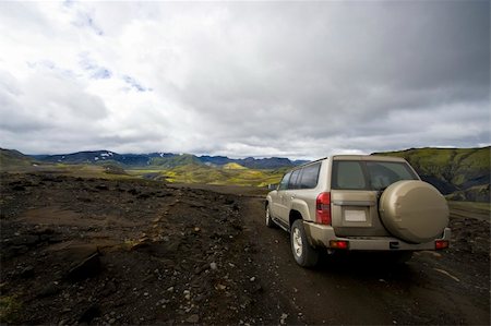 An all terrain car emerging from the grim lava fields into the meadows of the beautiful Landmannalaugar national park in Iceland Stock Photo - Budget Royalty-Free & Subscription, Code: 400-04923200