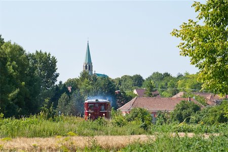 simsearch:400-07429824,k - little red train passing through the village and the countryside Stock Photo - Budget Royalty-Free & Subscription, Code: 400-04923754