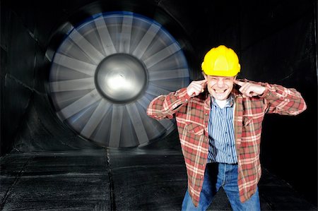 An engineer, covering his ears to protect them from the noise of a wintunnel being tested Stock Photo - Budget Royalty-Free & Subscription, Code: 400-04923891