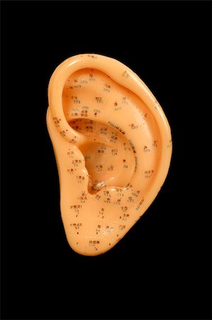 acupuncture points on ear isolated on black background Fotografie stock - Microstock e Abbonamento, Codice: 400-04934080