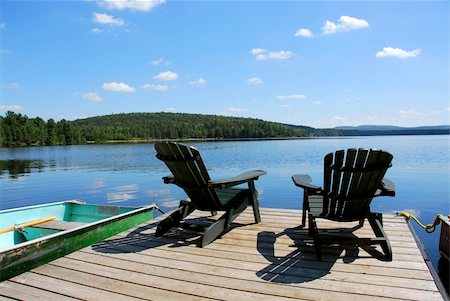 simsearch:400-03929357,k - Two adirondack wooden chairs on dock facing a blue lake with clouds reflections Foto de stock - Super Valor sin royalties y Suscripción, Código: 400-04934256