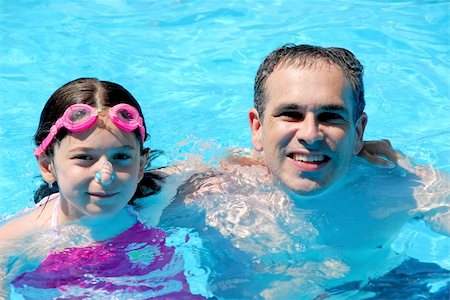 father daughter water splashing - Father and daughter having fun in a swimming pool Stock Photo - Budget Royalty-Free & Subscription, Code: 400-04934876