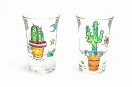 Shooter glasses with cactus painted on them over white backdrop Stock Photo - Budget Royalty-Free & Subscription, Code: 400-04935541