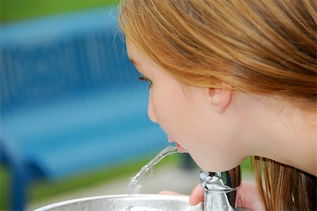 Young girl drinking water from a water fountain in a park Stock Photo - Budget Royalty-Free & Subscription, Code: 400-04936930