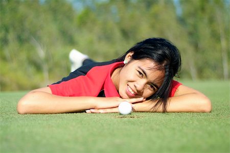 Young, female golf player with ball, at the hole on green Stock Photo - Budget Royalty-Free & Subscription, Code: 400-04937037