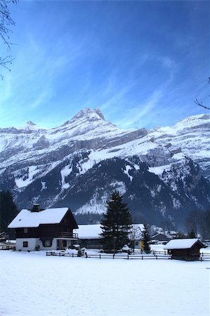 simsearch:400-06132736,k - Snow covered winter homes against the backdrop of mountains and blue sky. Stock Photo - Budget Royalty-Free & Subscription, Code: 400-04937397