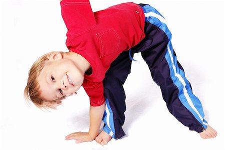 simsearch:400-08401650,k - A cute four year old boy wearing red and blue bending over to touch his right toes. Foto de stock - Royalty-Free Super Valor e Assinatura, Número: 400-04937668