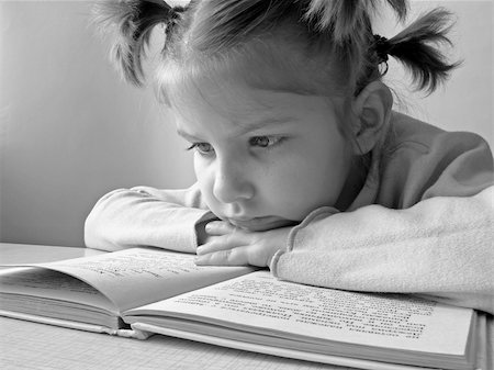 black and white portrait of the small pretty reading girl Stock Photo - Budget Royalty-Free & Subscription, Code: 400-04937716